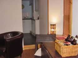 The sitting room looking into the kitchen at Kingston Apartment 1