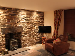 Kingston lodge - sitting room with stone wall